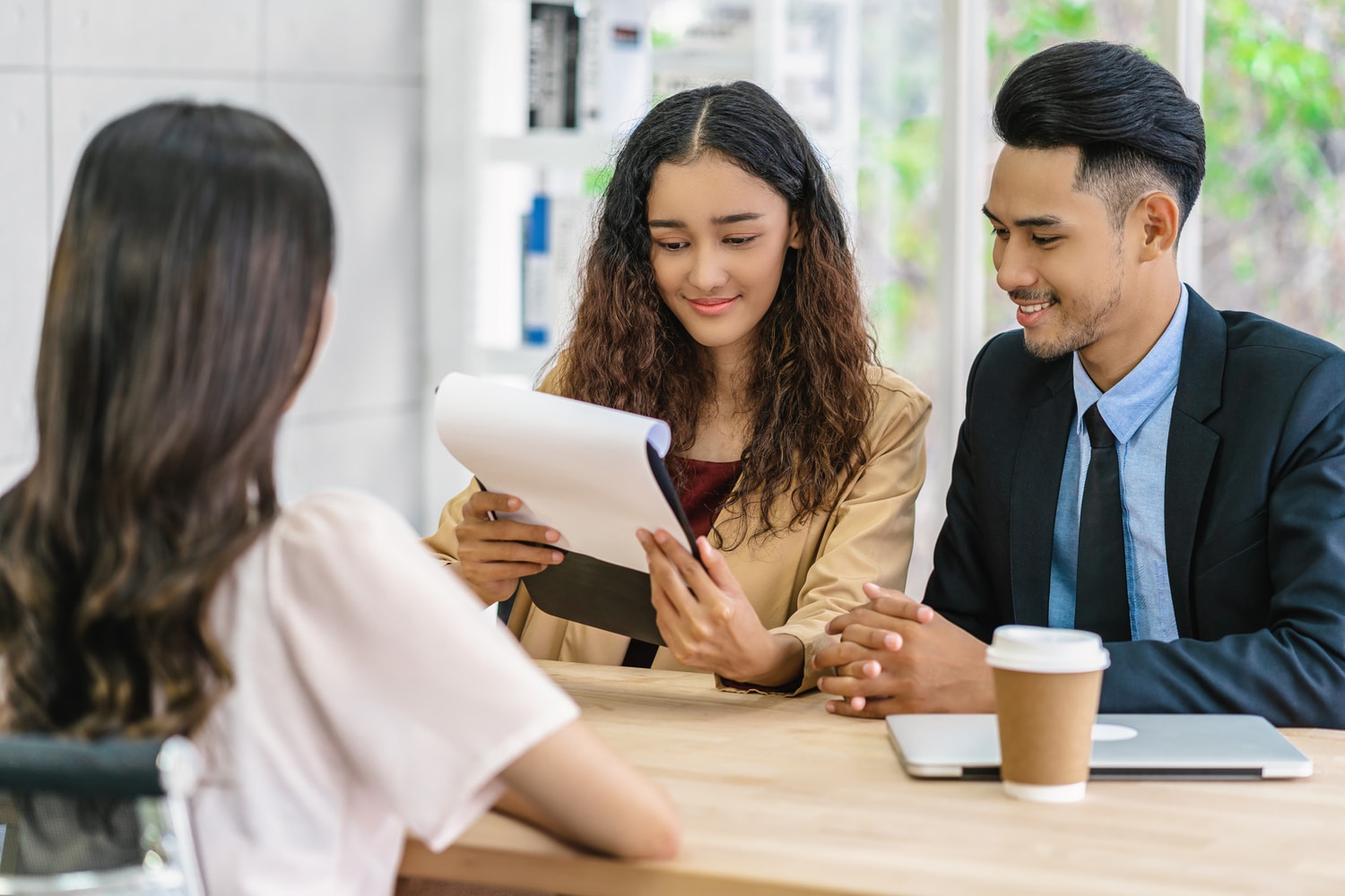 Business meeting with document review, highlighting COFINS in Brazil’s role in financial and social security management.